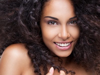 Depositphotos_25289921_s Portrait of a beautiful young African woman smiling.