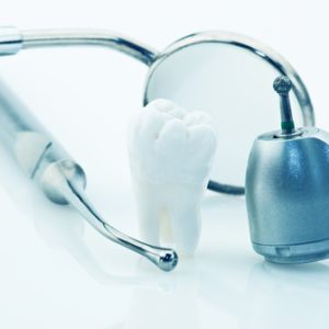 Depositphotos_3732211_s-2015 Healthy teeth concept. Real human wisdom tooth and dental tools. Blue tinted image